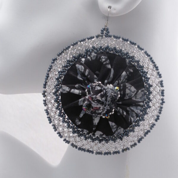 Ankara fabric round-shaped earrings in classic black and white, adorned with matching seed beads. Handcrafted with precision and passion. These earrings seamlessly blend cultural charm with contemporary flair.
